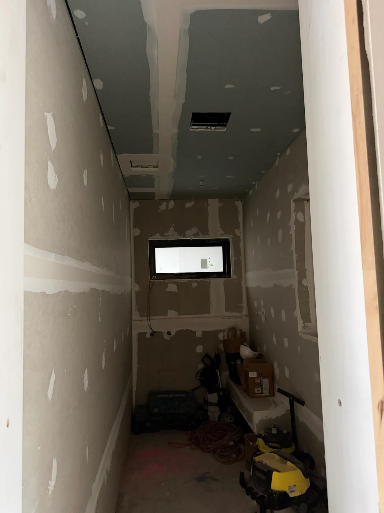 Kensington WC under construction with an unfinished ceiling opening above